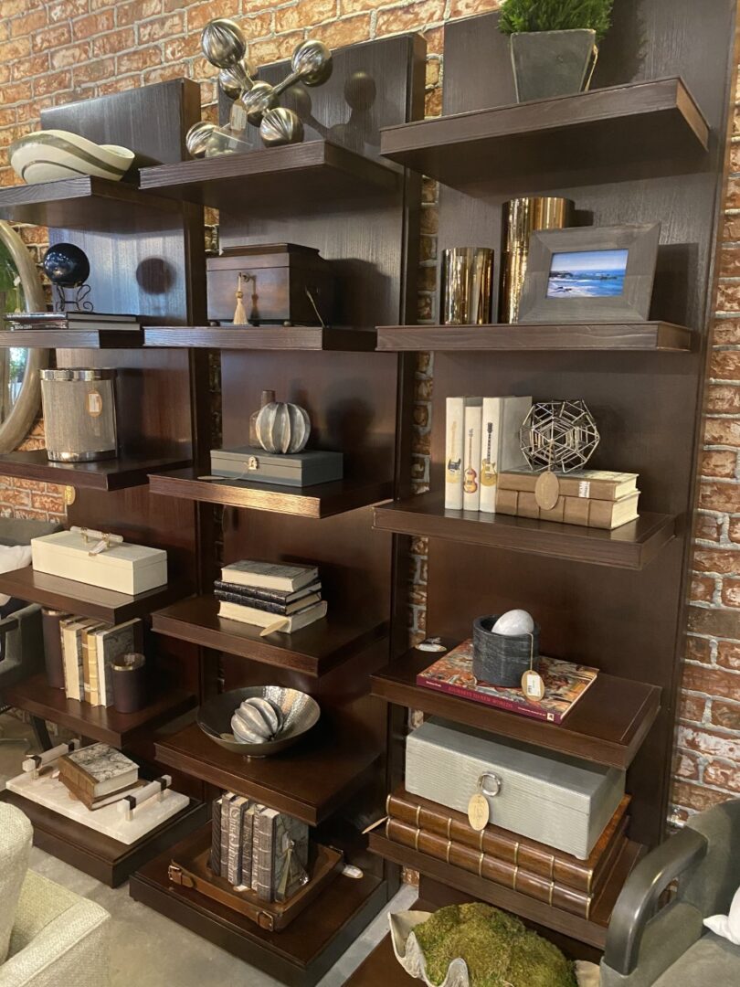 A bookshelf with many books and vases on it