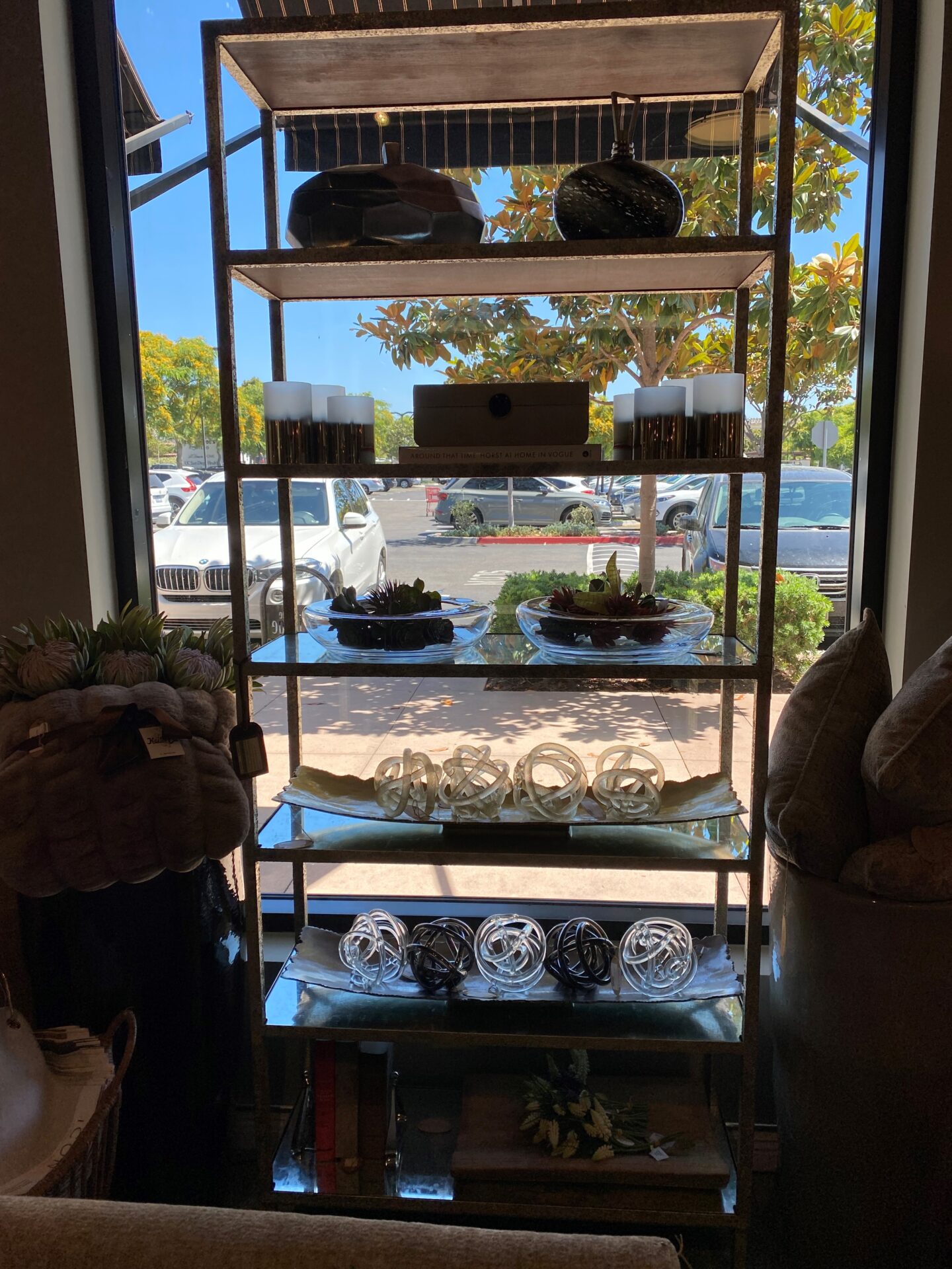 A window with shelves and bowls on it