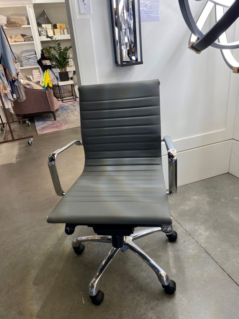 A gray office chair in an empty room.