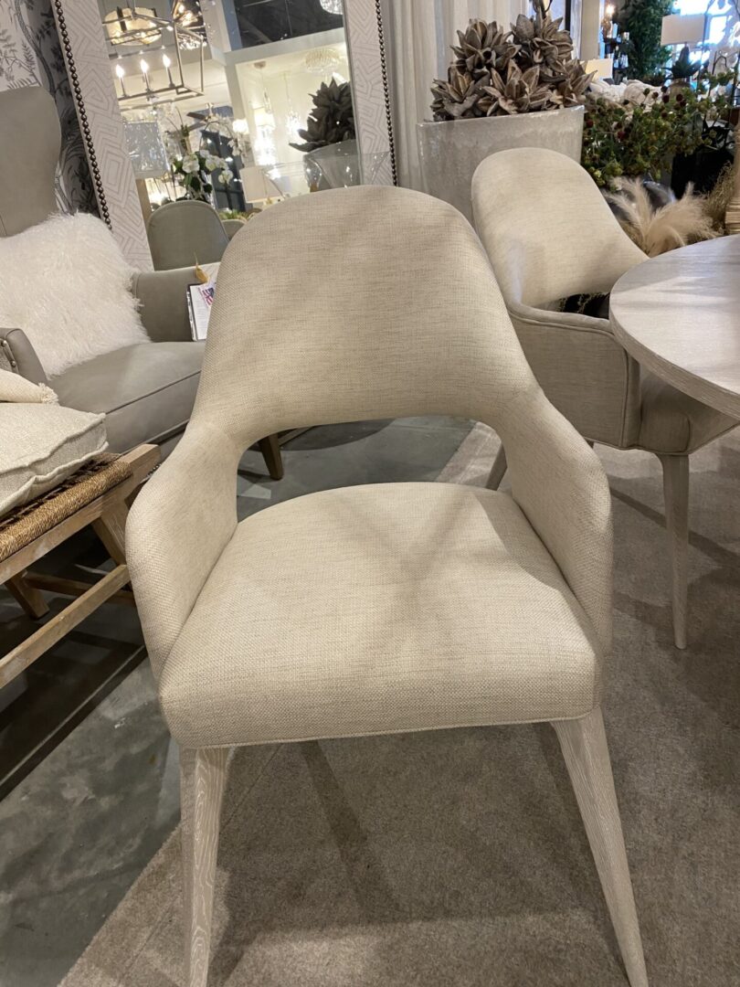 A white chair with arms and back rest