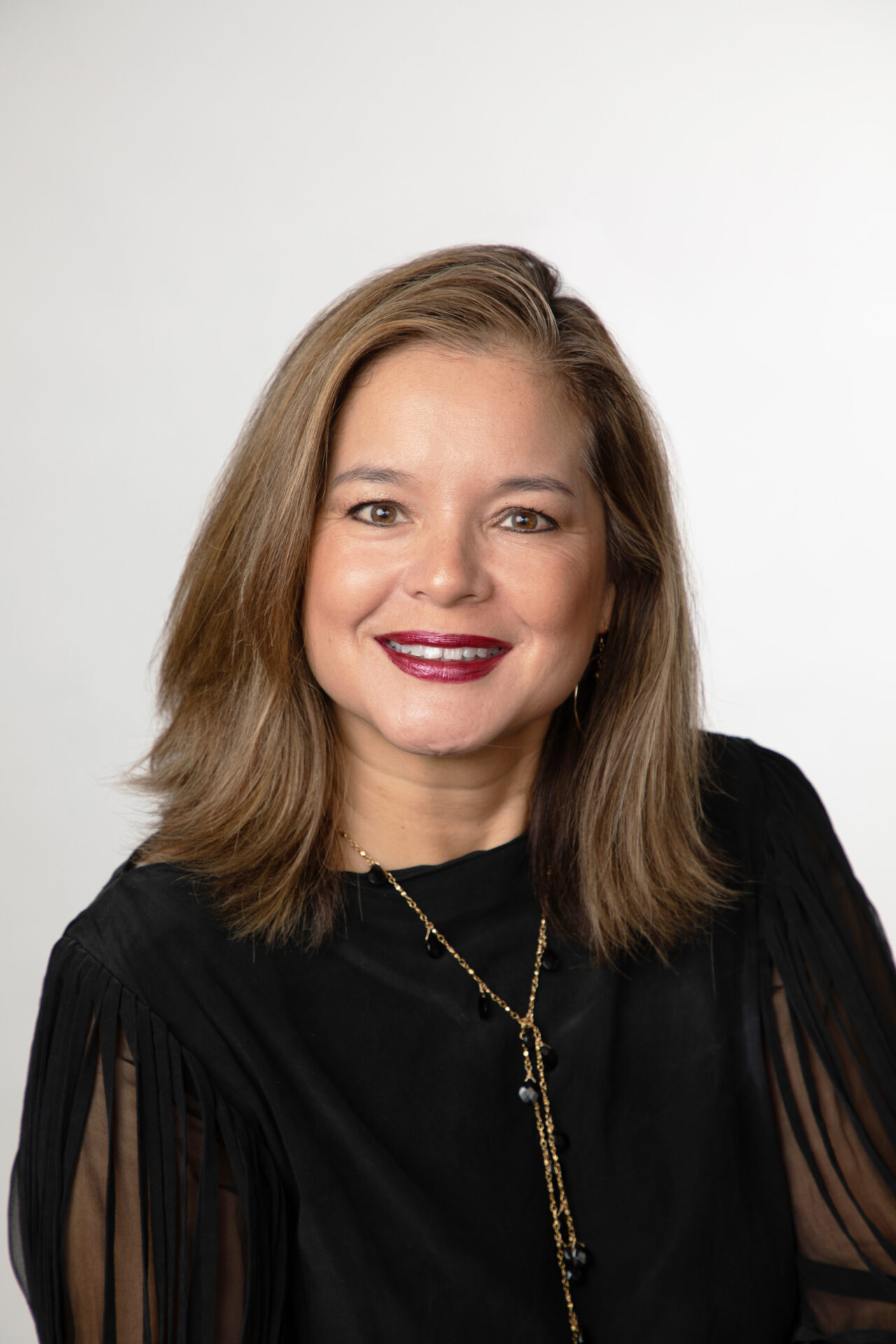 A woman with brown hair and red lipstick.