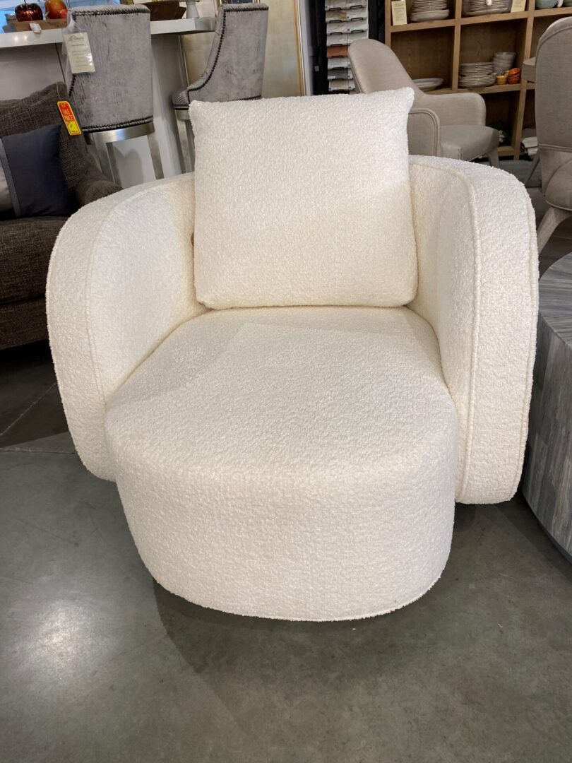 A white chair with ottoman in the middle of it